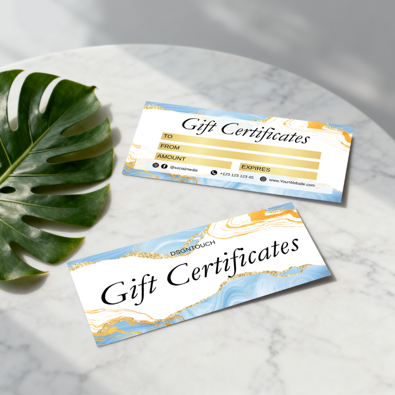 Watercolor Gift Cards displayed on a marble surface with tropical leaves, featuring elegant design and customizable fields.