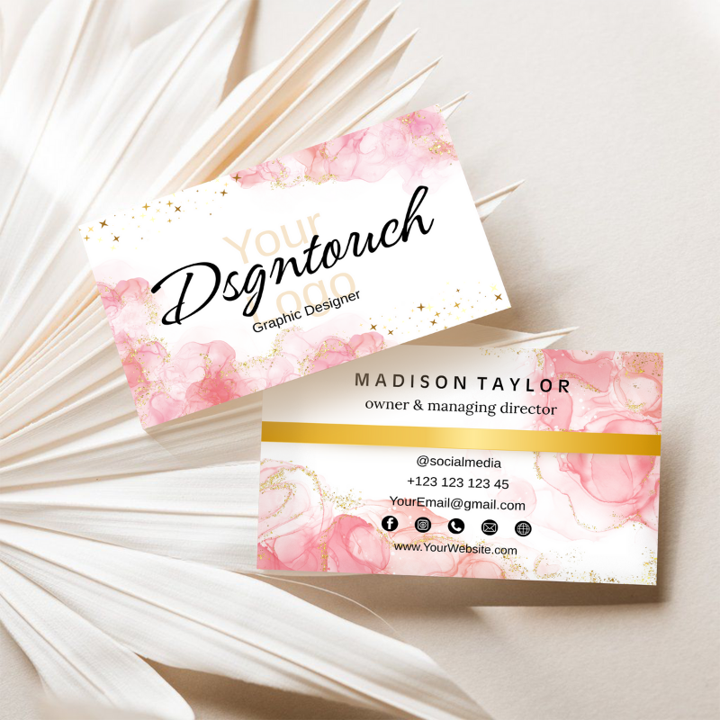 An elegant flat lay of our pink gloss business cards arranged neatly on a modern office desk with a pen and laptop.