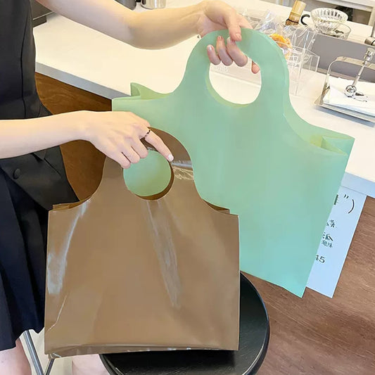 Custom poly bags for clothing in brown and green colors, perfect for branding and protecting apparel.