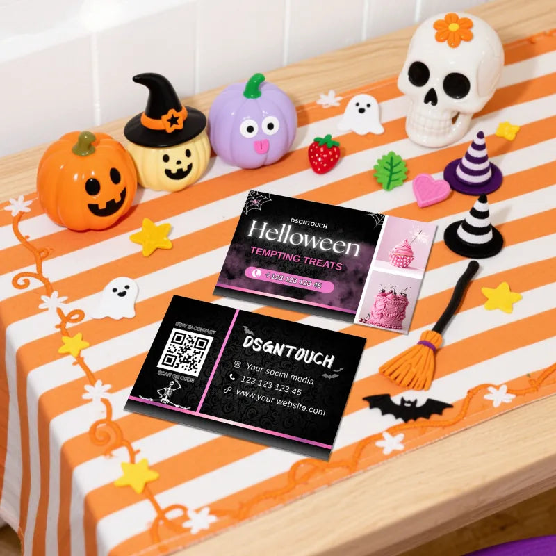 Halloween Cake Business Cards for Bakeries - 300GSM Gloss Laminated - DSGNTOUCH displayed on a festive table with decorations.