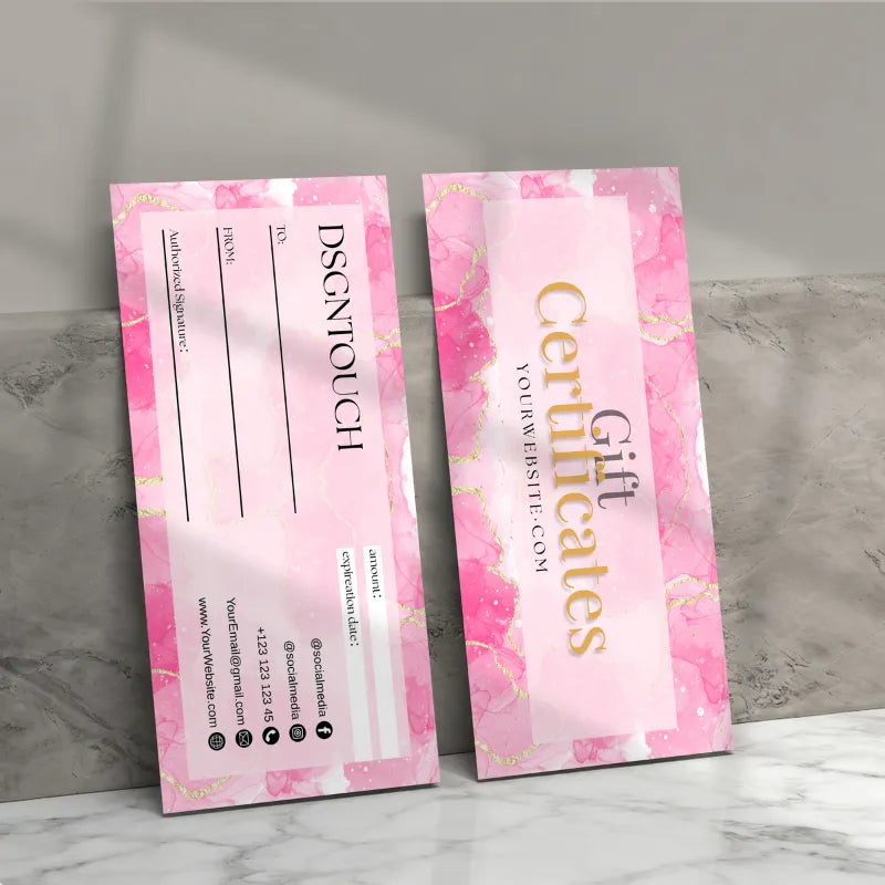 Printable gift certificate template displayed on a marble surface, featuring pink design and elegant font.
